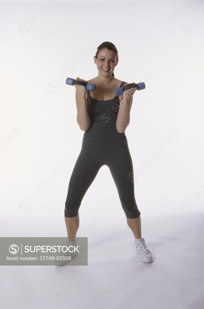 Stock Photo: 1574R-03508 Portrait of a young woman exercising with dumbbells