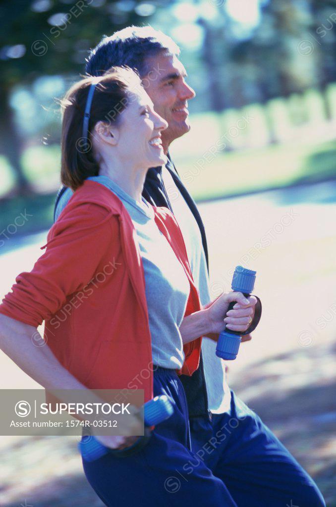 Stock Photo: 1574R-03512 Side profile of a mid adult couple jogging together