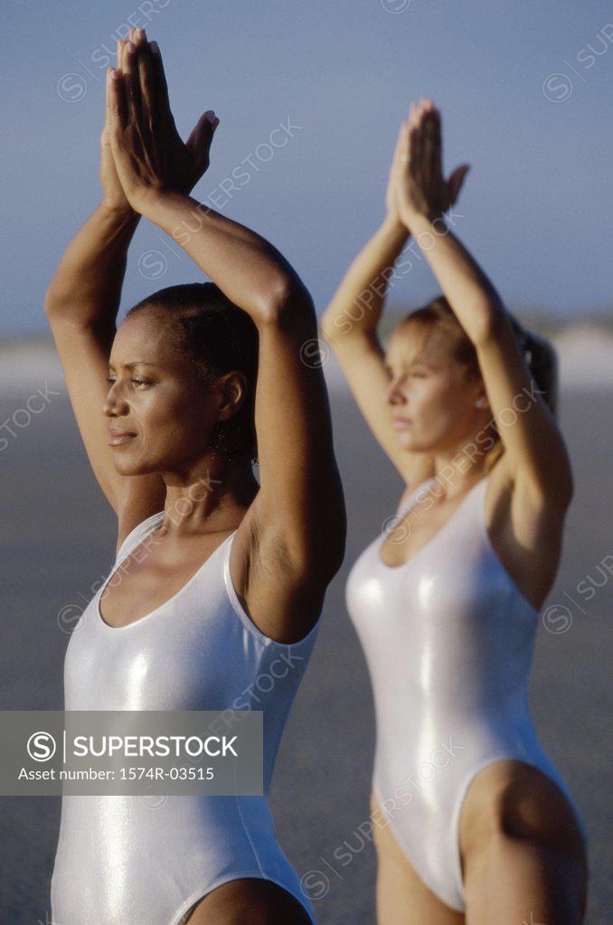 Stock Photo: 1574R-03515 Two young women exercising on the beach