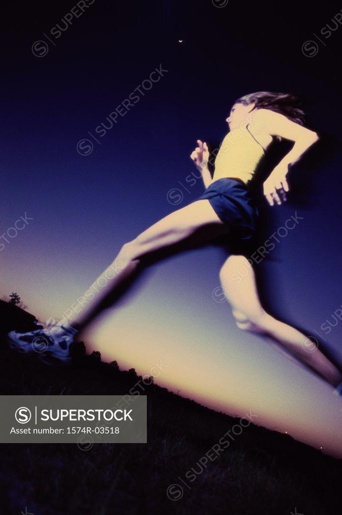 Stock Photo: 1574R-03518 Low angle view of a young woman running