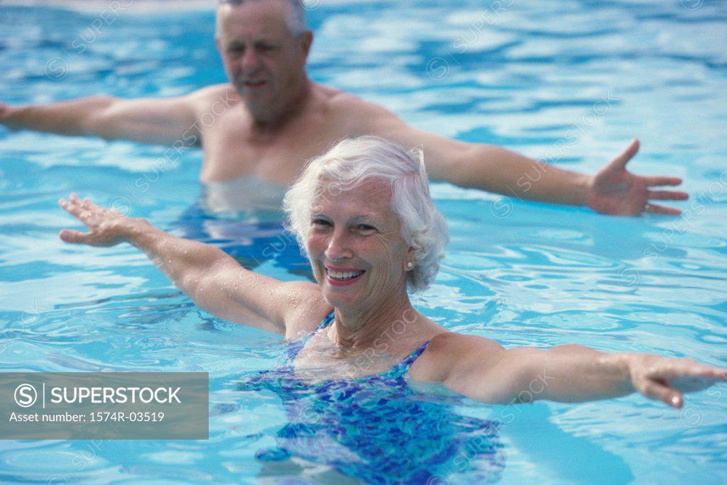 Stock Photo: 1574R-03519 Portrait of a senior couple stretching in a swimming pool