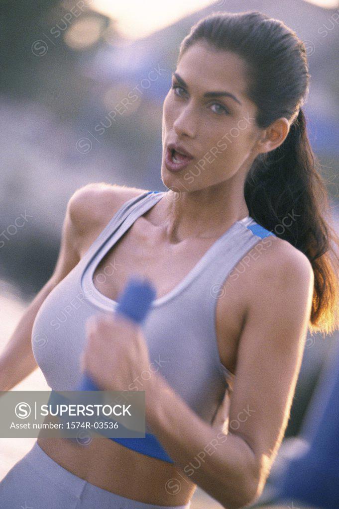 Stock Photo: 1574R-03536 Side profile of a young woman exercising