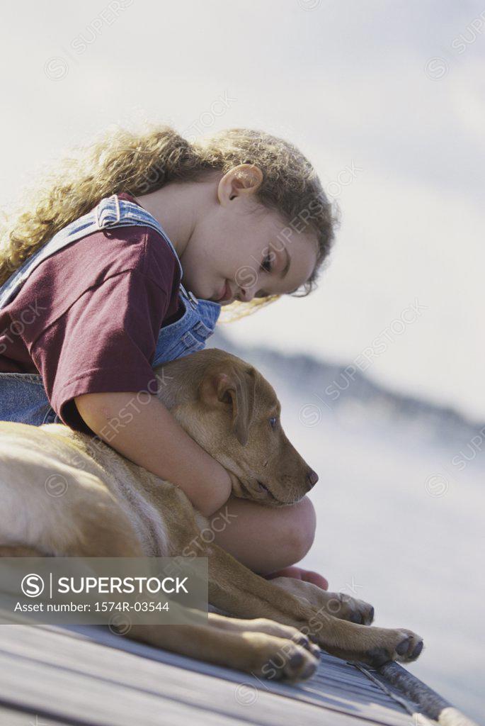 Stock Photo: 1574R-03544 Girl sitting with her dog