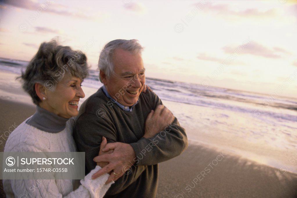 Stock Photo: 1574R-0355B Senior couple standing at the beach