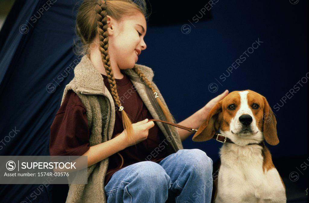 Stock Photo: 1574R-03576 Girl sitting with her dog