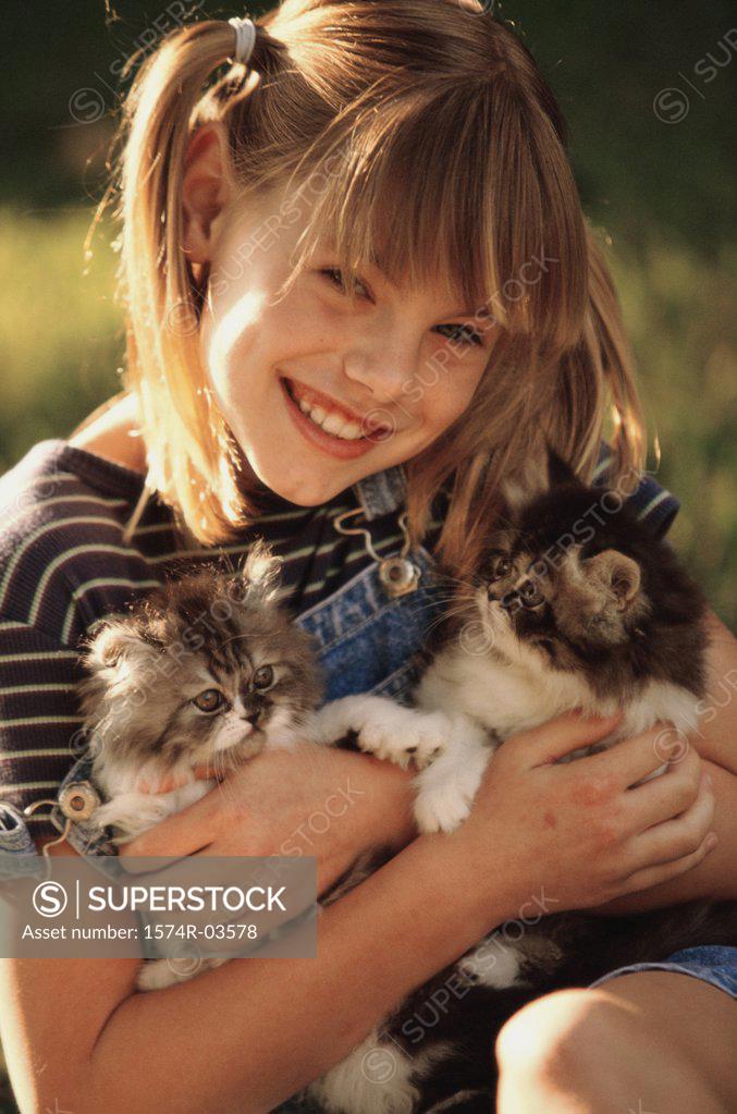 Stock Photo: 1574R-03578 Portrait of a girl holding cats