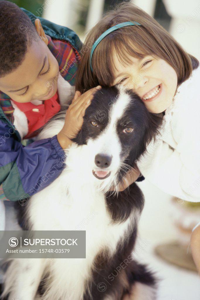 Stock Photo: 1574R-03579 Portrait of a girl and a boy petting a dog