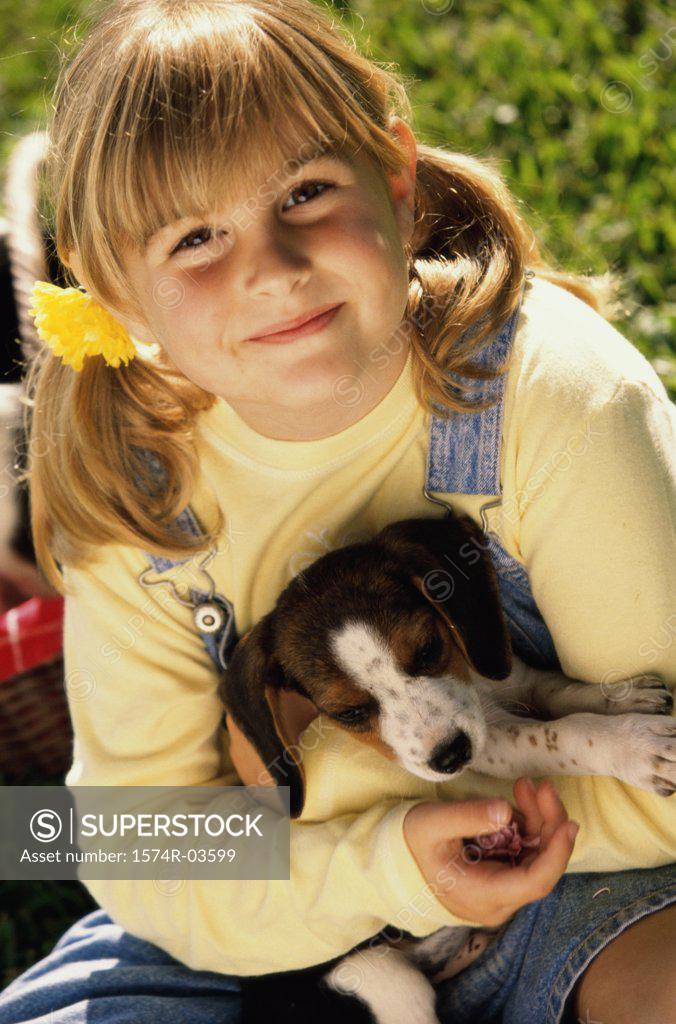 Stock Photo: 1574R-03599 High angle view of a girl sitting with her puppy