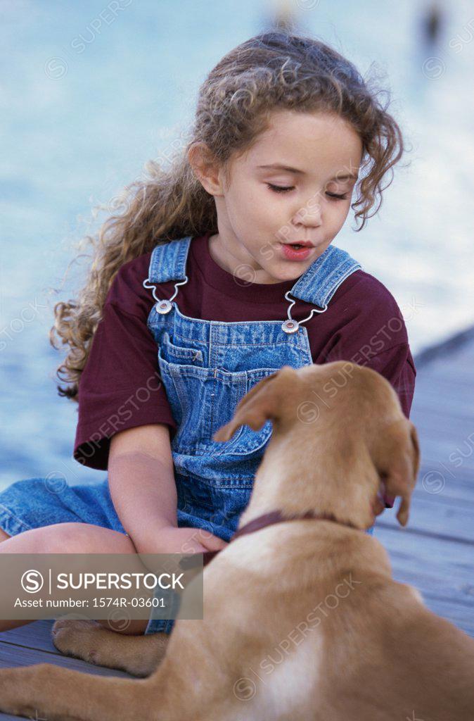 Stock Photo: 1574R-03601 Close-up of a girl sitting with her dog