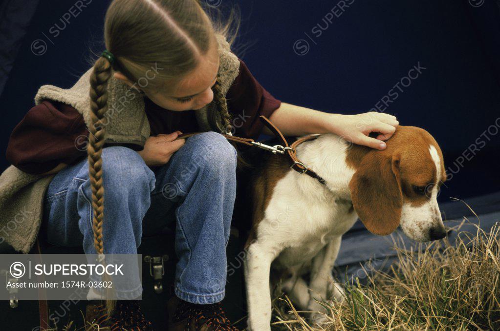 Stock Photo: 1574R-03602 Girl sitting with her dog