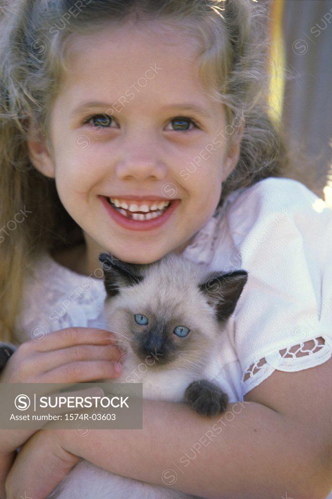 Stock Photo: 1574R-03603 Close-up of a girl holding a Siamese kitten