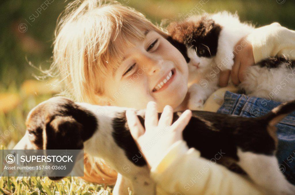 Stock Photo: 1574R-03605 Close-up of a girl holding a puppy and a kitten