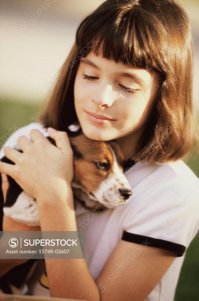 Stock Photo: 1574R-03607 Close-up of a girl holding her puppy