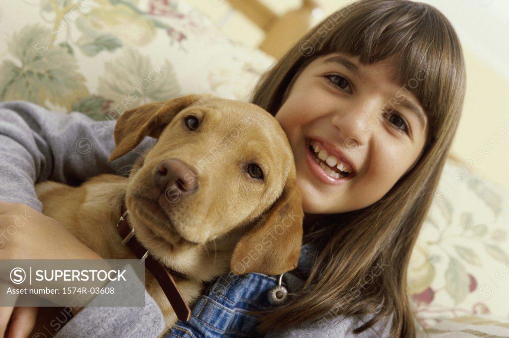 Stock Photo: 1574R-03608 Portrait of a girl holding her dog