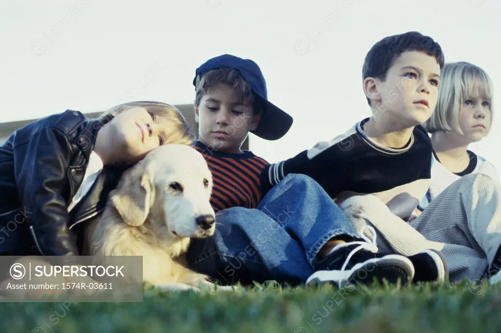 Group of children sitting with their dog