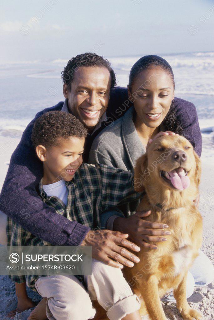 Stock Photo: 1574R-03620 Parents with their son holding a dog