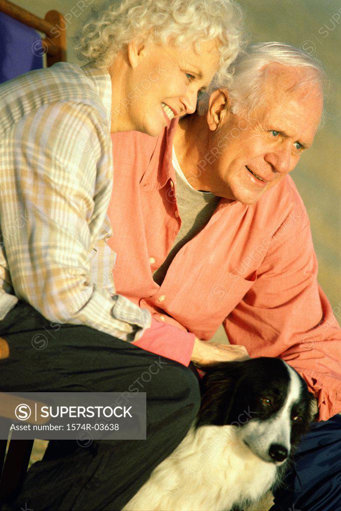 Stock Photo: 1574R-03638 Senior couple sitting with their dog