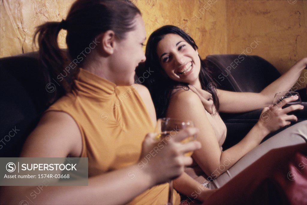 Stock Photo: 1574R-03668 Two young women sitting in a bar