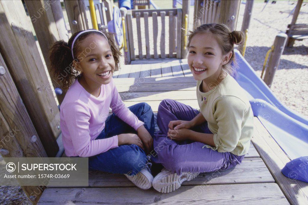 Stock Photo: 1574R-03669 Portrait of two girls sitting