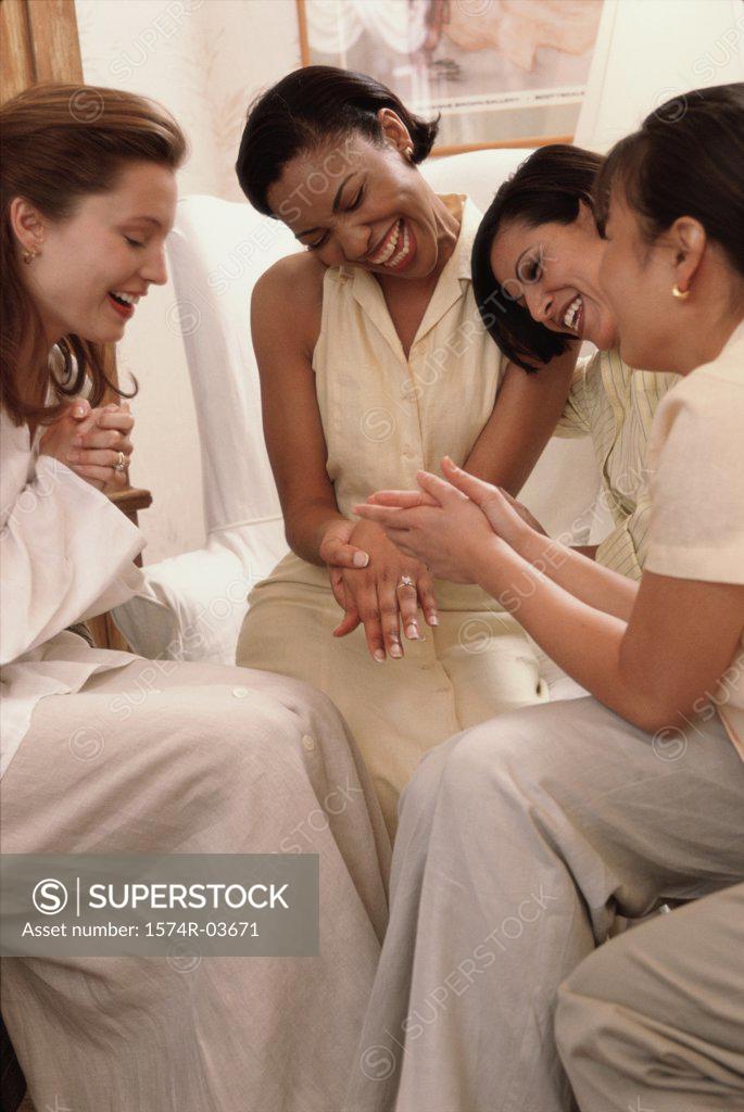 Stock Photo: 1574R-03671 Young woman showing her engagement ring to her friends