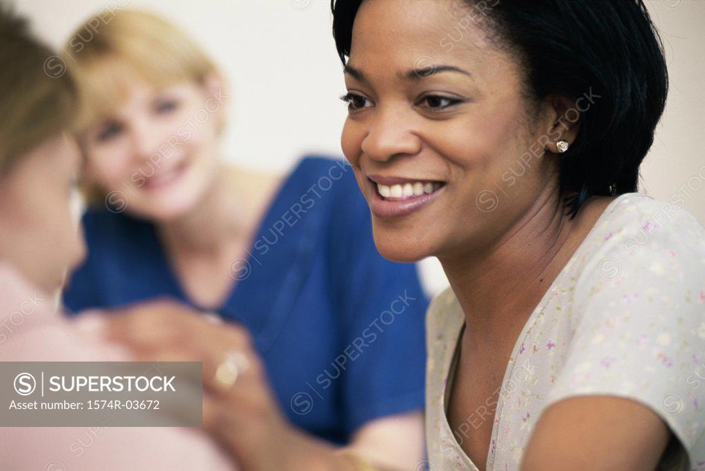 Stock Photo: 1574R-03672 Three young women sitting together