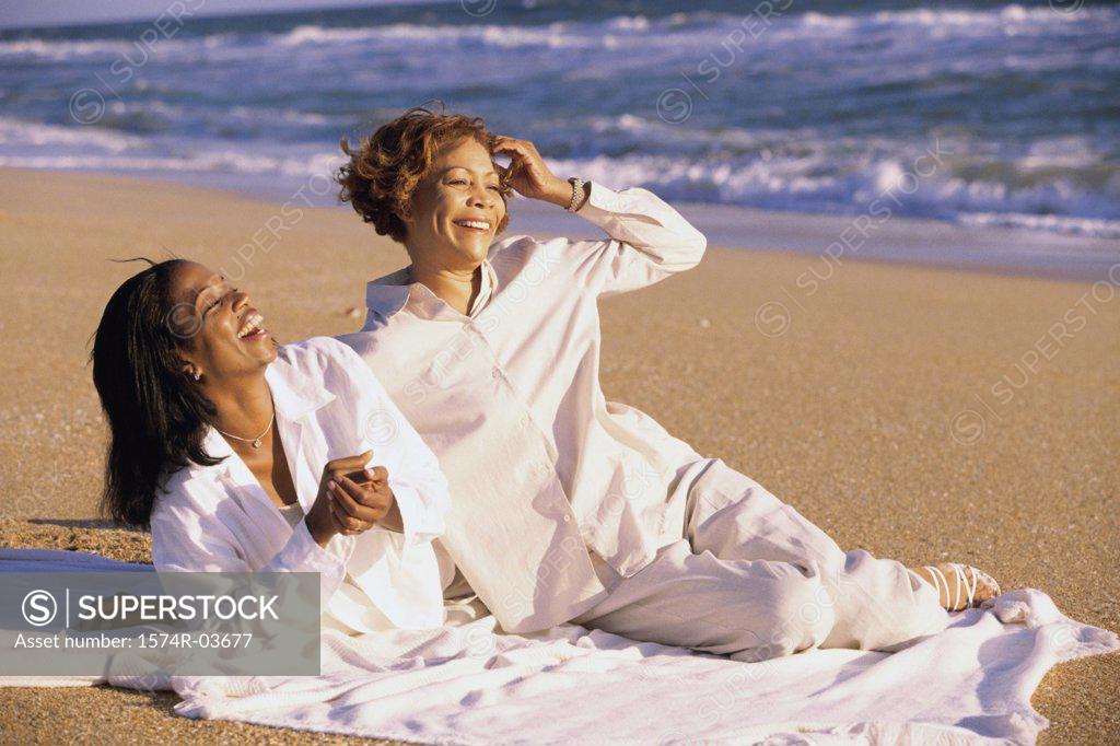 Stock Photo: 1574R-03677 Mother and her daughter lying on the beach