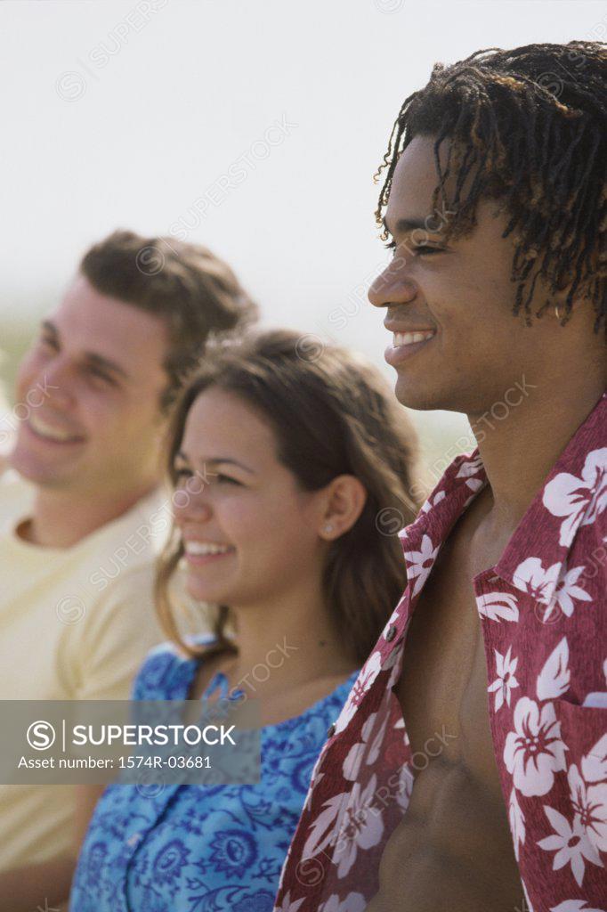 Stock Photo: 1574R-03681 Side profile of two teenage boys and a teenage girl smiling