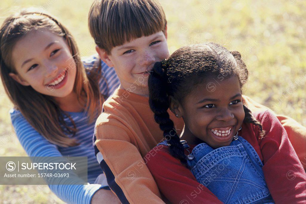 Stock Photo: 1574R-03693 Close-up of two girls and a boy playing