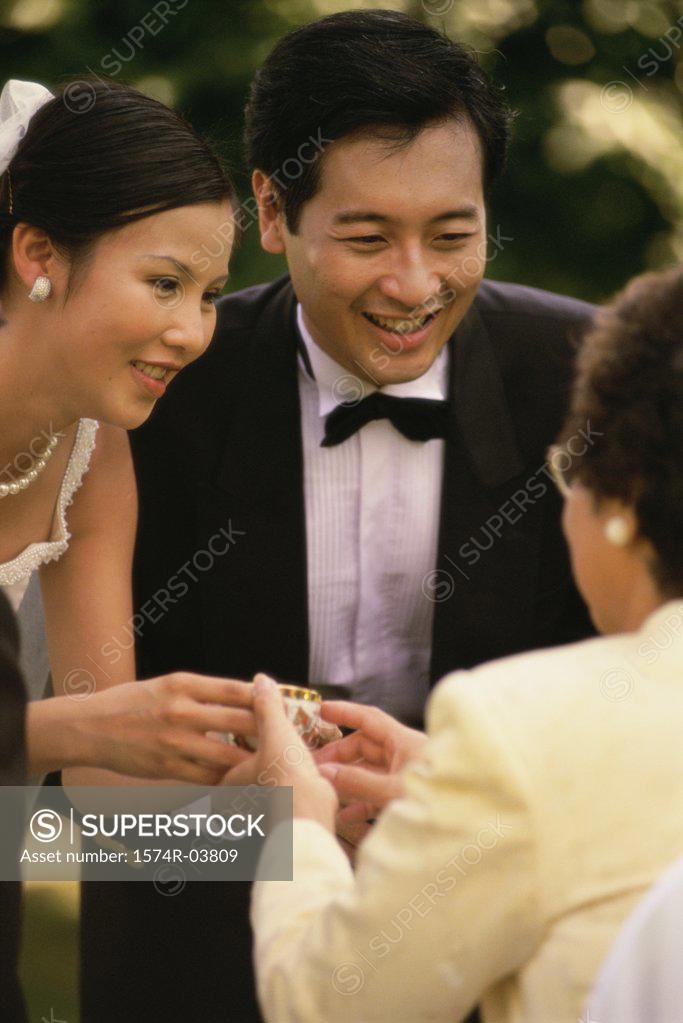 Stock Photo: 1574R-03809 Bride offering tea to her mother