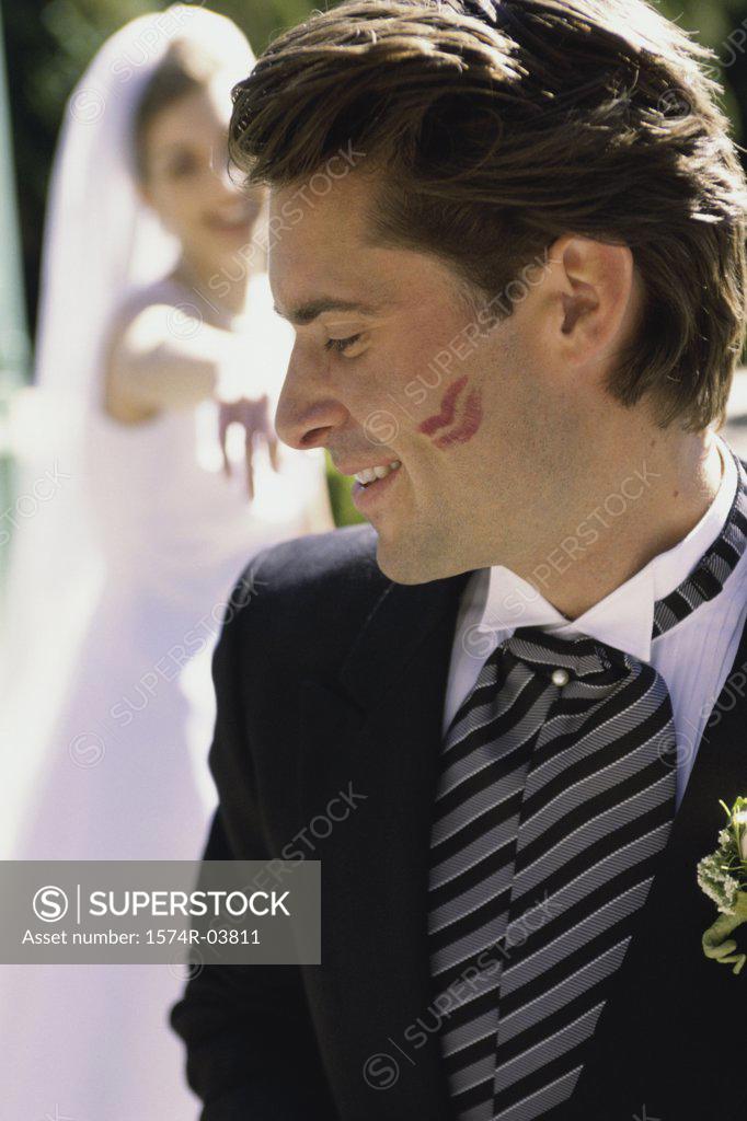 Stock Photo: 1574R-03811 Close-up of a groom with lipstick marks on his cheek