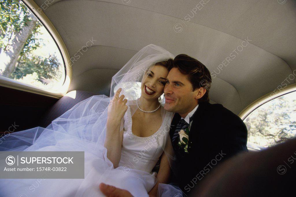 Stock Photo: 1574R-03822 Bride and groom sitting in a car