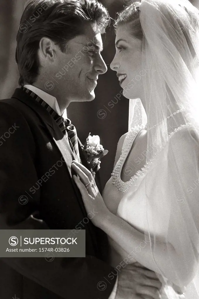 Side profile of a newlywed couple looking at each other