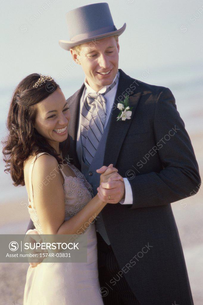 Stock Photo: 1574R-03831 Young couple dancing on the beach