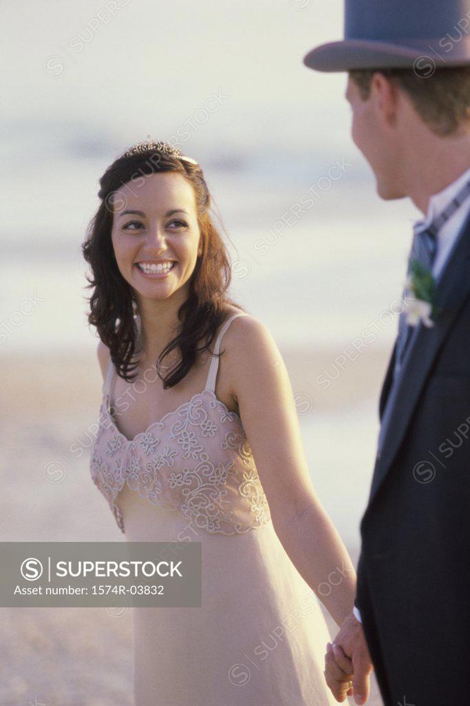 Stock Photo: 1574R-03832 Young couple walking on the beach