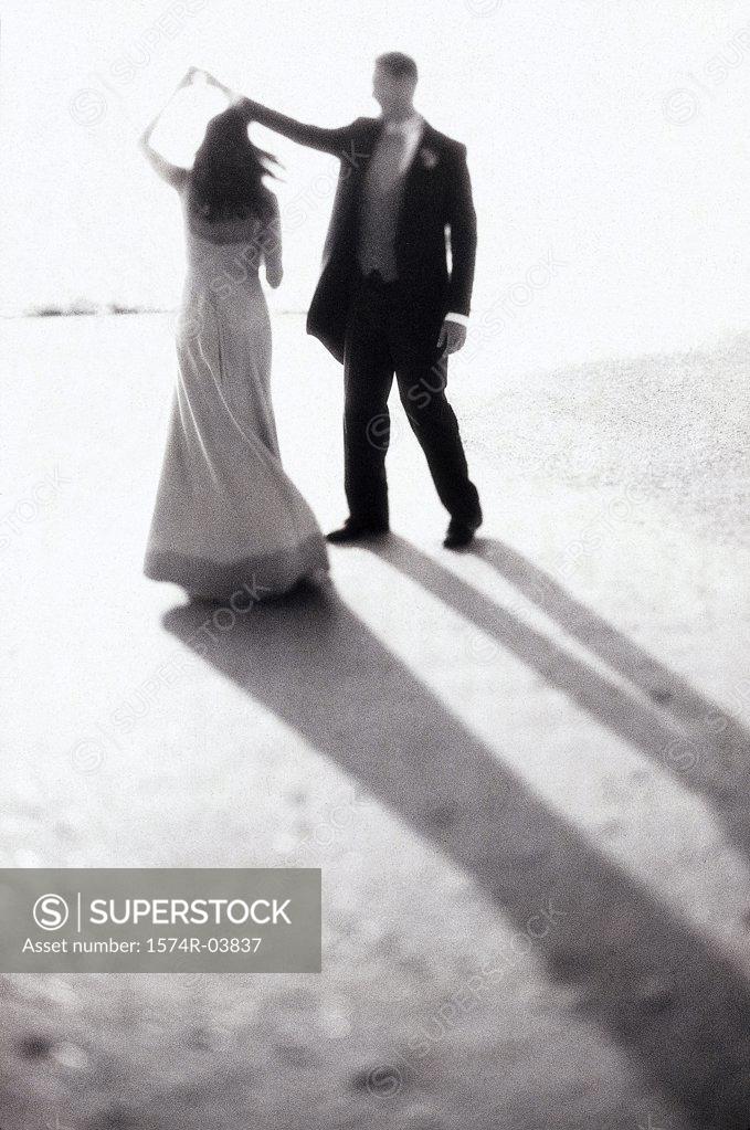 Stock Photo: 1574R-03837 Young couple dancing on the beach