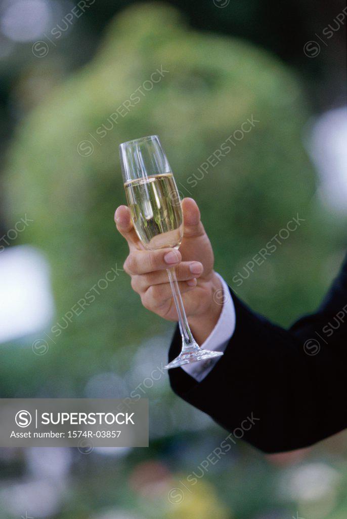 Stock Photo: 1574R-03857 Close-up of a person's hand holding a champagne flute