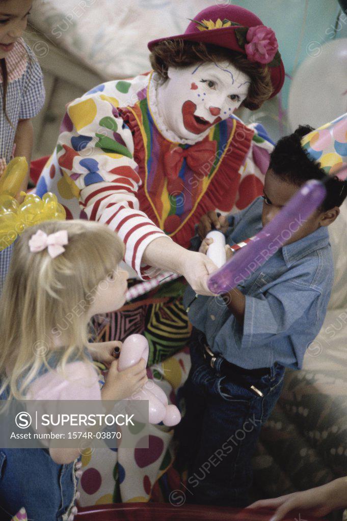 Stock Photo: 1574R-03870 High angle view of a clown playing with children at a birthday party