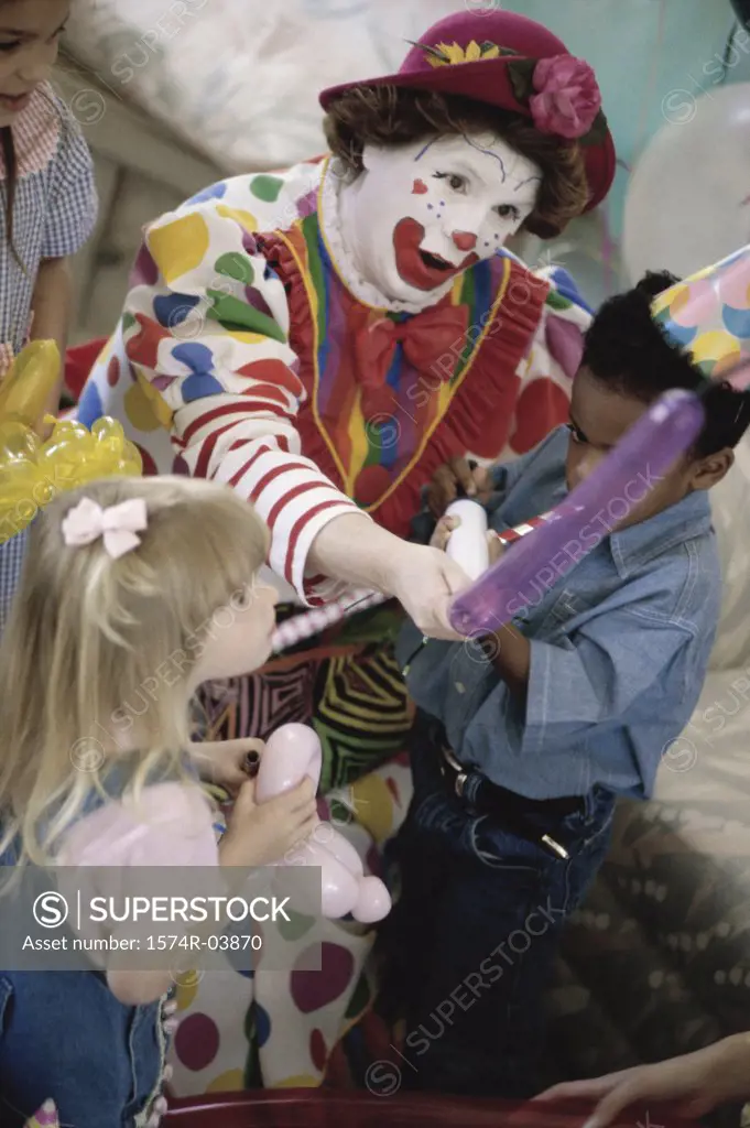 High angle view of a clown playing with children at a birthday party