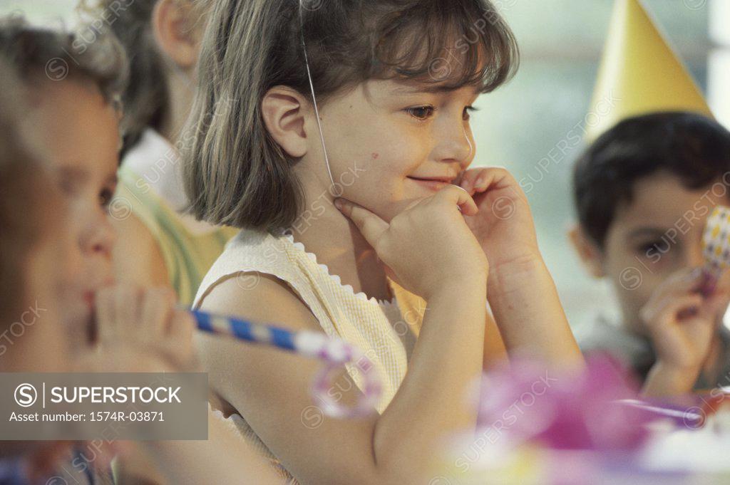 Stock Photo: 1574R-03871 Group of children blowing party horn blower at a birthday party