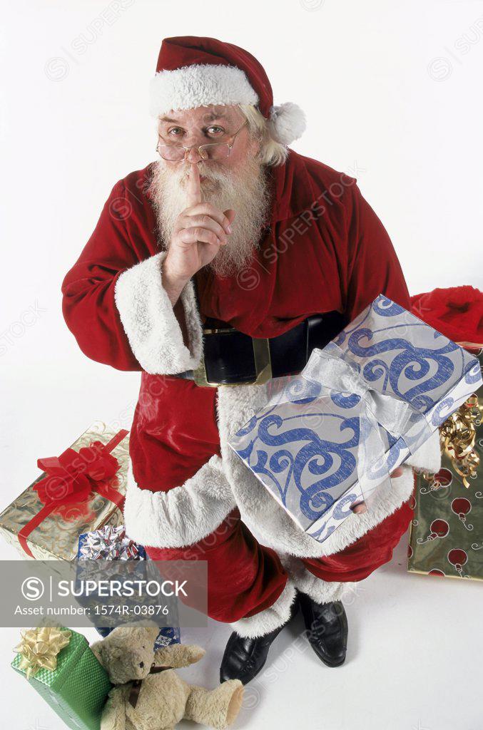 Stock Photo: 1574R-03876 High angle view of Santa Claus with his finger on his lips