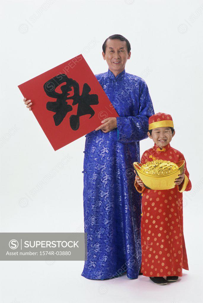 Stock Photo: 1574R-03880 Portrait of a mid adult man holding a poster and a pot of gold with his son