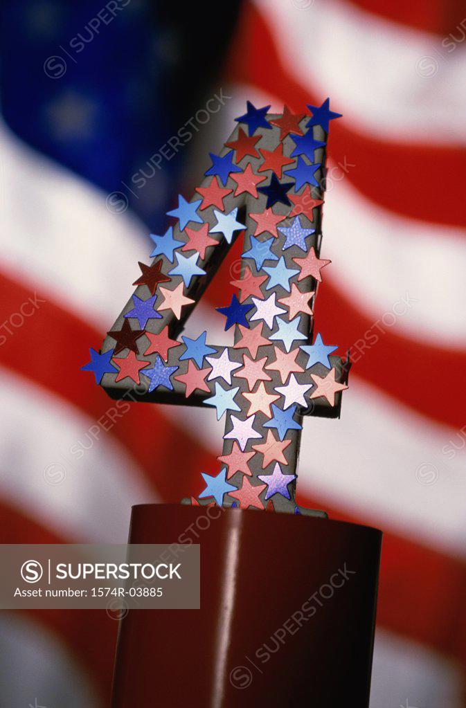 Stock Photo: 1574R-03885 Number four covered with stars and the American flag in the background