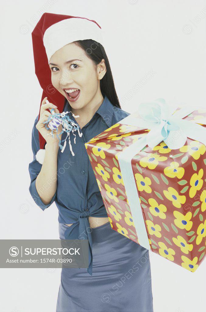 Stock Photo: 1574R-03890 Portrait of a young woman holding a gift
