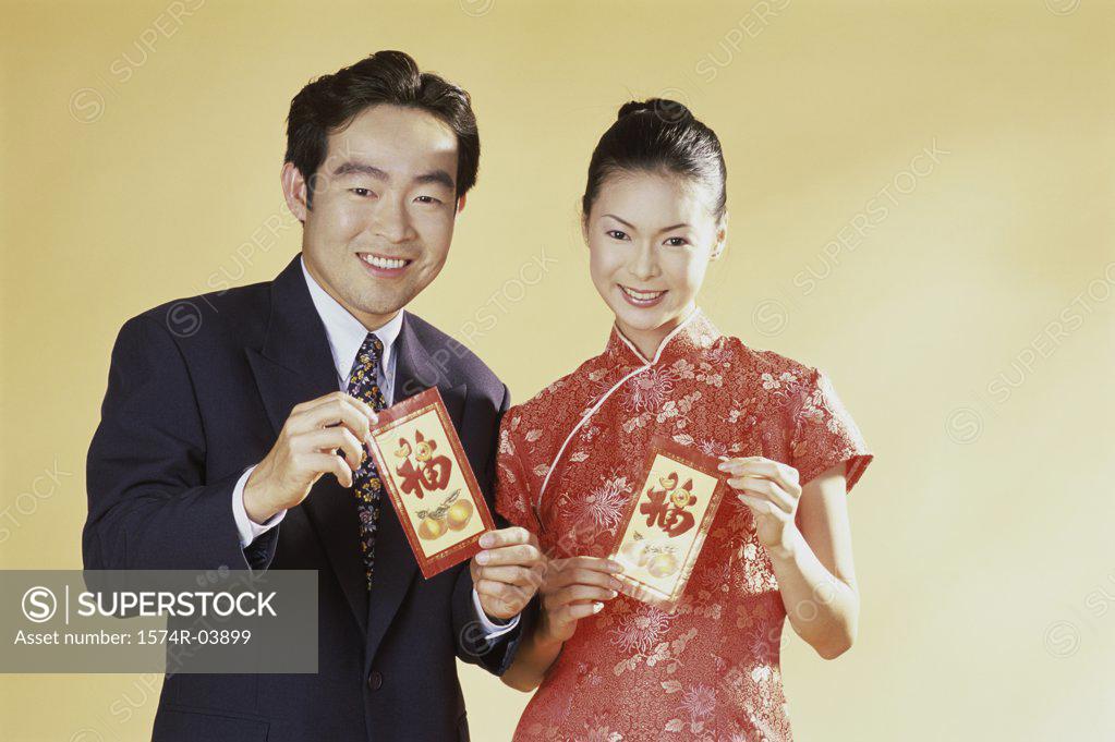Stock Photo: 1574R-03899 Portrait of a young couple holding greeting cards