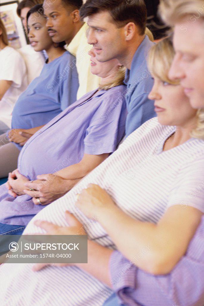 Stock Photo: 1574R-04000 Husbands and their pregnant wives at a prenatal class