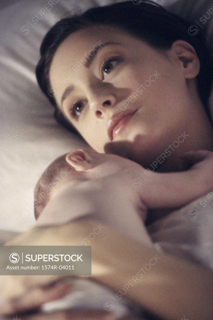 Stock Photo: 1574R-04011 Close-up of a mother lying down with her baby boy