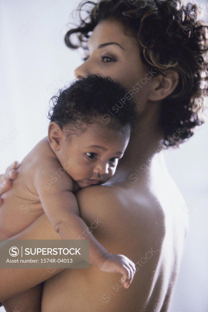 Stock Photo: 1574R-04013 Side profile of a mother carrying her baby boy