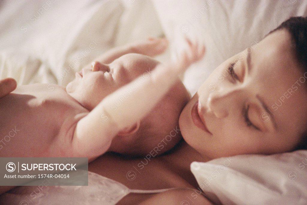 Stock Photo: 1574R-04014 Close-up of a mother lying down with her baby boy