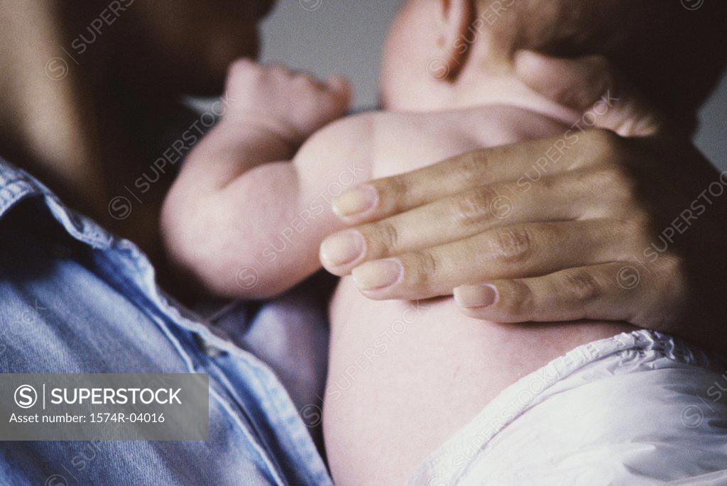 Stock Photo: 1574R-04016 Close-up of a mother carrying her baby boy