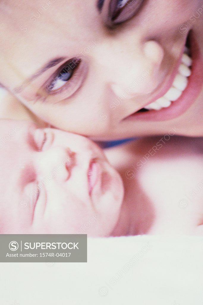 Stock Photo: 1574R-04017 Close-up of a mother carrying her baby boy
